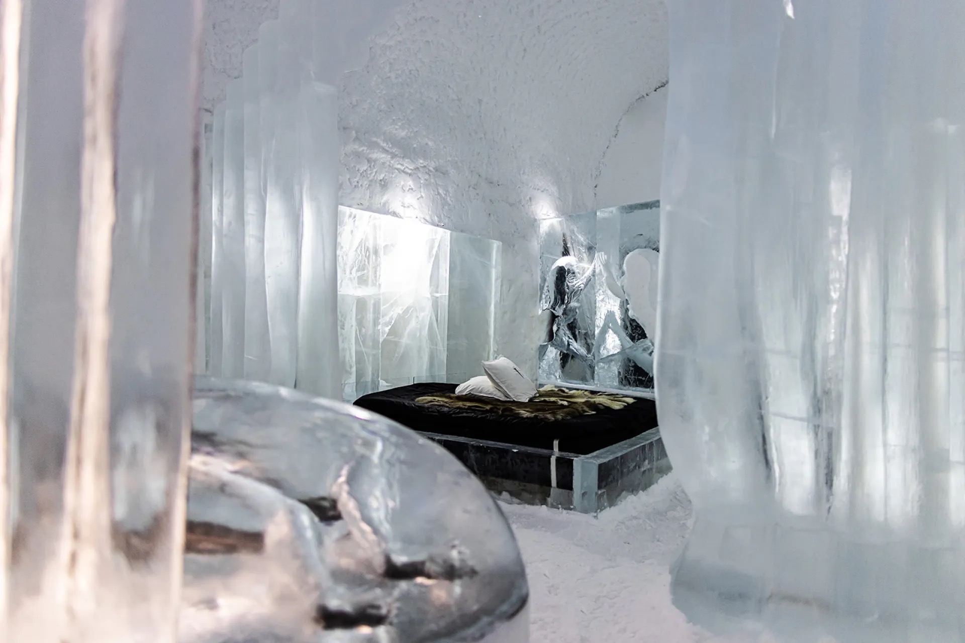 A carved corridor of packed snow and ice inside a hotel that is rebuilt every winter.