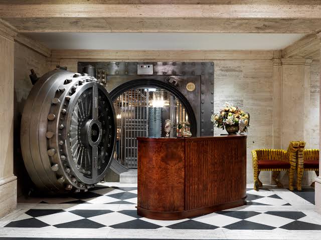 The former Midland Bank banking hall at The Ned in London, with rows of columns between dining tables.