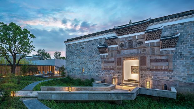 A rebuilt Ming dynasty courtyard house at Amanyangyun in Shanghai, standing among transplanted camphor trees.