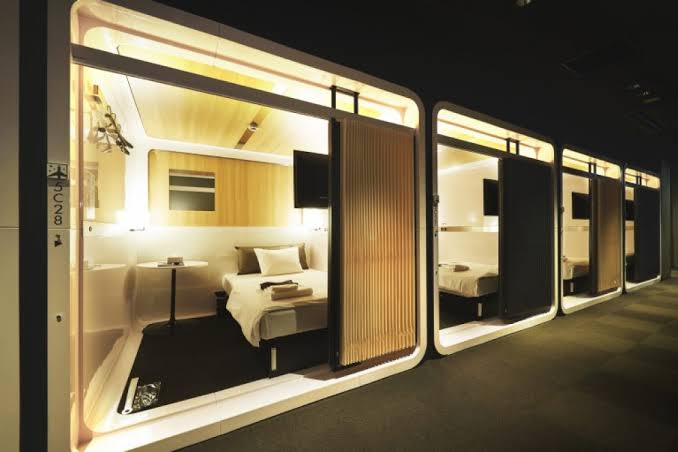A corridor of First Cabin in Tokyo, lined with cabins sized like a first-class seat area and closed by curtains.