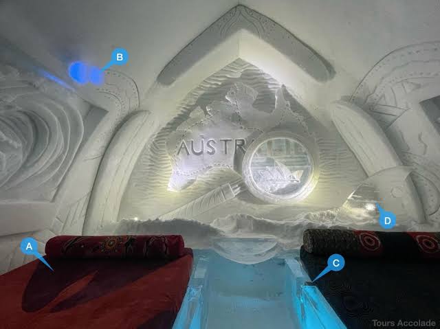 A vaulted snow corridor with ice columns at Hotel de Glace near Quebec City.